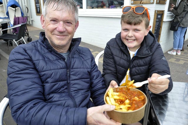 Michael Holmes, 10, enjoying curry and chips at Roker Beach with his grandfather Jim Cassidy, 62.  

Picture by FRANK REID