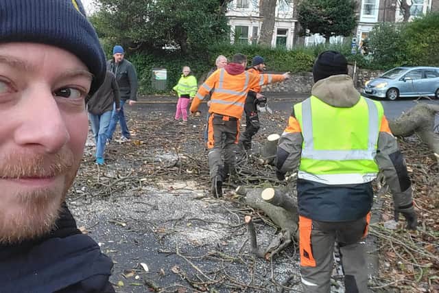 People join together to help clear a fallen tree in Tunstall Road.