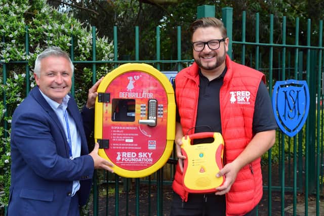 St Mary's RC Primary School headteacher Martin Clephane and Red Sky Foundation founder Sergio Petrucci with the defibrillator unit on the outside of the school premises.