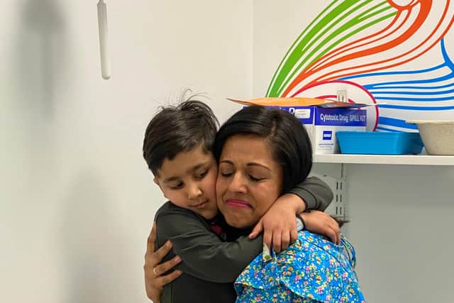 Saahib and mum Gurpreet Randhawa enjoy a hug after he rang the treatment bell.
