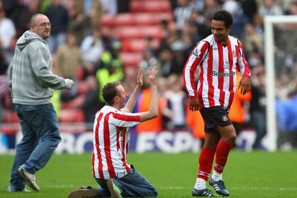 A Sunderland fan sinks to his knees in front of goalscorer Kieran Richardson of Sunderland at the end of the Barclays Premier League match between Sunderland and Newcastle United at the Stadium of Light on October 25, 2008.