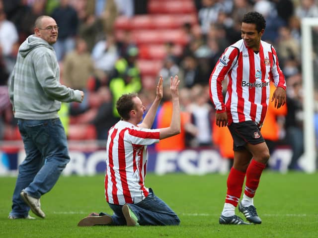 A Sunderland fan sinks to his knees in front of goalscorer Kieran Richardson of Sunderland at the end of the Barclays Premier League match between Sunderland and Newcastle United at the Stadium of Light on October 25, 2008.