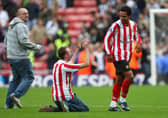A Sunderland fan sinks to his knees in front of goalscorer Kieran Richardson of Sunderland at the end of the Barclays Premier League match between Sunderland and Newcastle United at the Stadium of Light on October 25, 2008.