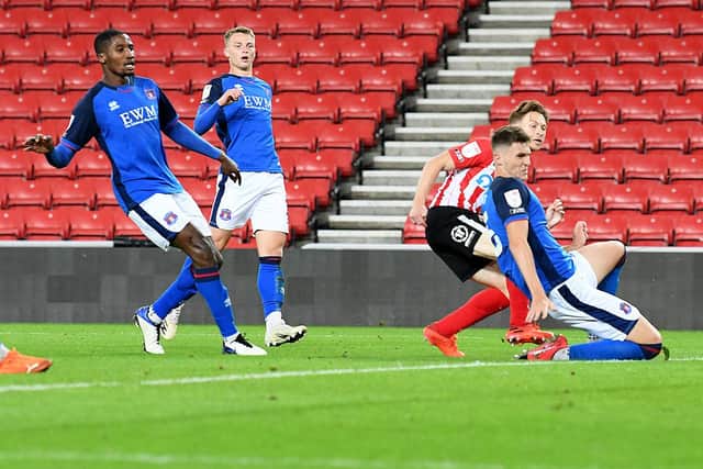 Denver Hume slides home Sunderland's second goal against Carlisle United