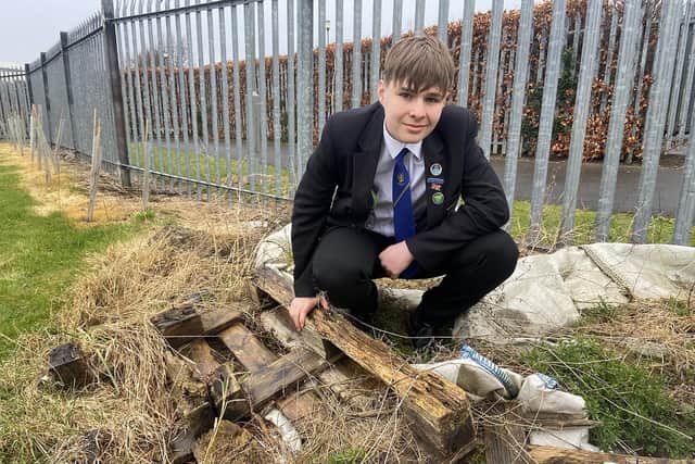 Naill Alston, 13, sets about clearing a plant bed. 

Picture by FRANK REID