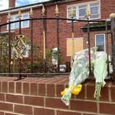 Floral tributes left outside the property on Minorca Close.