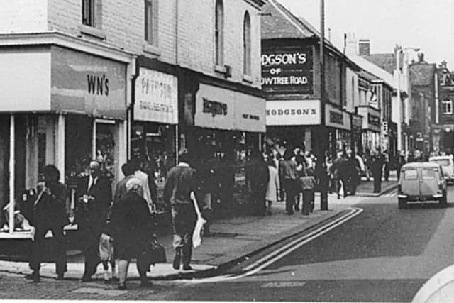 A busy Crowtree Road with Esquire boutique in the picture.