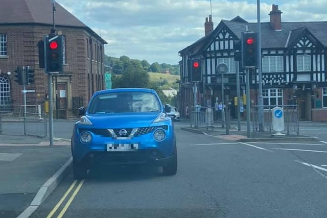 This driver decided parking in front of the traffic lights, facing oncoming traffic, was the perfect place to leave their car.