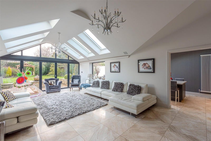 The attractive sun room is bathed in light from the Velux windows overhead and enjoys views over the private rear garden, which can be accessed via the bi-folding patio doors.