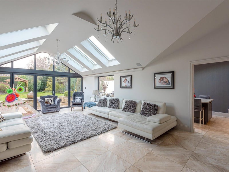The attractive sun room is bathed in light from the Velux windows overhead and enjoys views over the private rear garden, which can be accessed via the bi-folding patio doors.