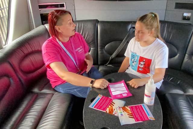 Nikki Donaldson, engagement officer for Together for Children, chatting with Talia Blench, 12, on the Summer Bus. 

Picture by Frank Reid