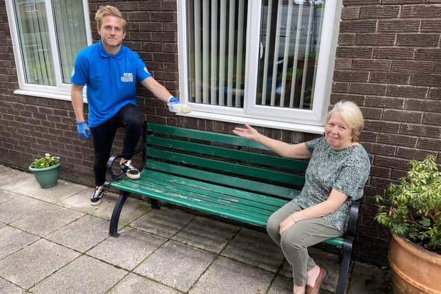 Manchester United U23 goalkeeper Paul Woolston chatting with Ann Garbutt, 73, after he delivered her lunch. Picture by Frank Reid.