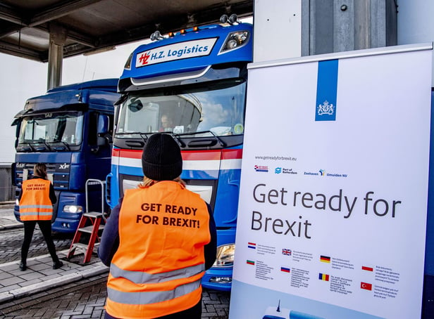 Flyers are distributed, as part of the Get Ready For Brexit campaign, to truck drivers at the terminal of a ferry operator in the port of Rotterdam on December 1, 2020.