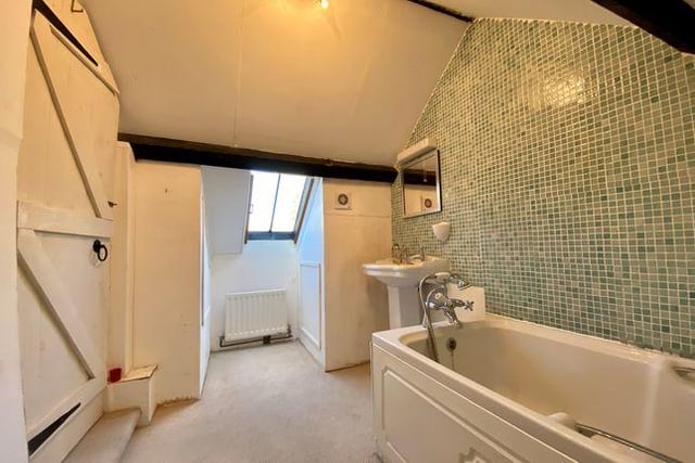 The ensuite bathroom provides plenty of space and also includes a double glazed window, sloping ceiling and feature beams