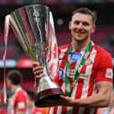Charlie Wyke of Sunderland celebrates with the Papa John's Trophy after the Papa John's Trophy Final match between Sunderland and Tranmere Rovers on March 14, 2021.