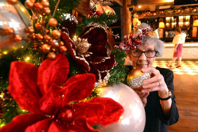 Local housing resident Audrey Dobson turns on the Seaburn Inn Christmas lights at the Christmas free lunch party.