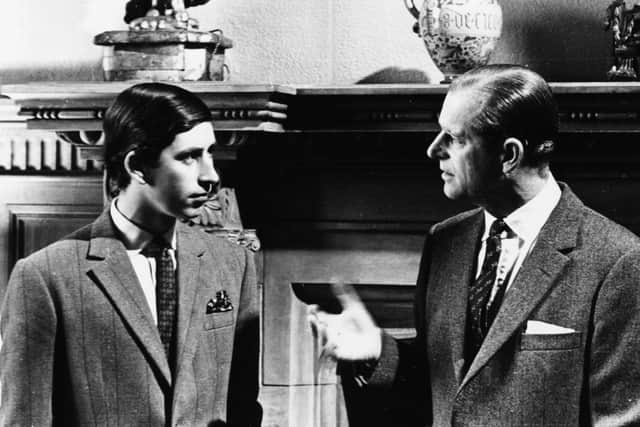 Prince Charles talking to his father, the Duke of Edinburgh, in front of a fireplace at Sandringham, Scotland, 1969. Picture: Central Press/Hulton Archive/Getty Images.