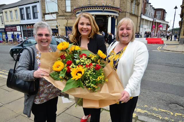 Theatre director Marie Nixon presents a boquet of flowers to sisters (left) Theresa Ford and Irene Bryden who were first in line as the Empire Theatre re-opens after 18 months. Picture by FRANK REID.