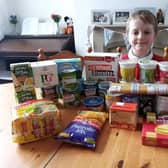 Elliot Hooper with the items he bought using his pocket money for a food bank