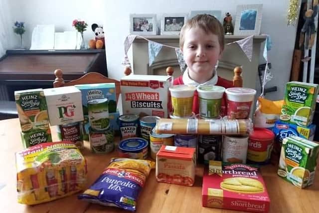 Elliot Hooper with the items he bought using his pocket money for a food bank