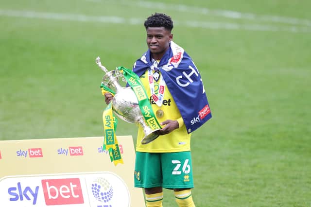 Bali Mumba of Norwich City celebrates with the Sky Bet Championship trophy following the Sky Bet Championship match between Barnsley and Norwich City at Oakwell Stadium.