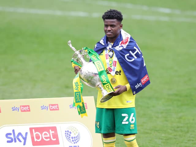 Bali Mumba of Norwich City celebrates with the Sky Bet Championship trophy following the Sky Bet Championship match between Barnsley and Norwich City at Oakwell Stadium.