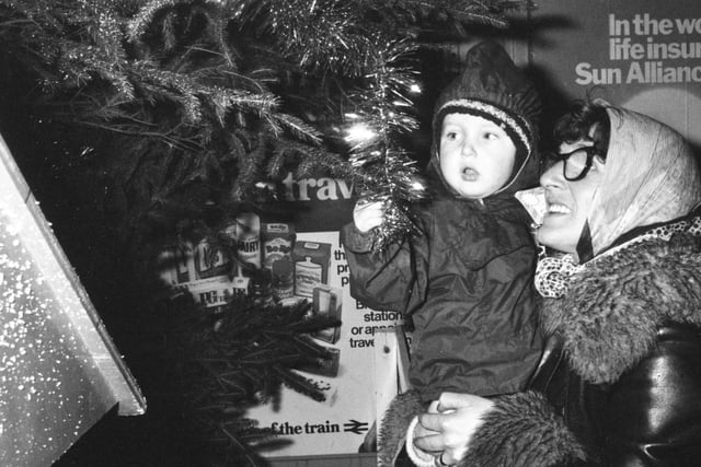 John Padget, 2, and his mother Mary Padgett, from Hylton Castle Estate, were taking a look at the Christmas tree in Sunderland Station after the lights switch on in 1981. The Human League were number 1 with Don't You Want Me.