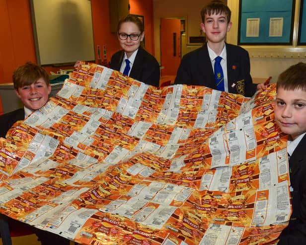 Pupils with one of their foil blankets made out of recycled crisp packets. (left to right) Charlie Hutchinson, 13, Peyton Lancaster, 12, Jay Ferry, 13, and Mitchell Peggie, 13.