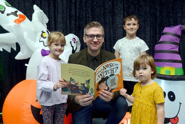 Author David Crosby with his latest book, Which Nose for Witch at the Bridges haunted grotto with children James, 9, Emily, 5 and Bethany Russell, 2.