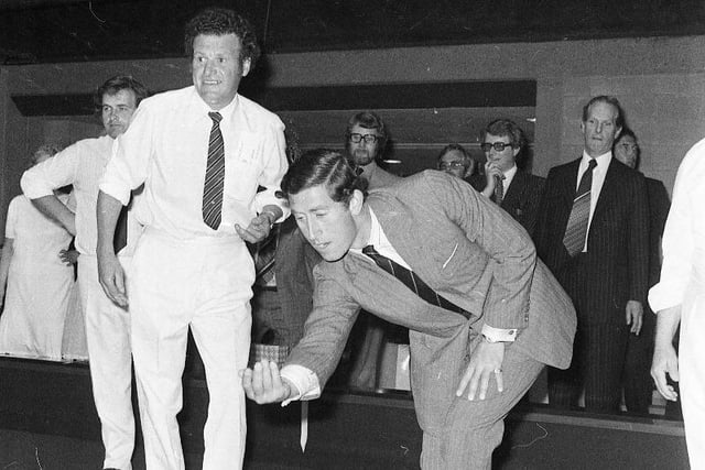 Sunderland Bowling Club member Gordon Thompson looks on as the Prince tries his hand at bowling on the indoor green