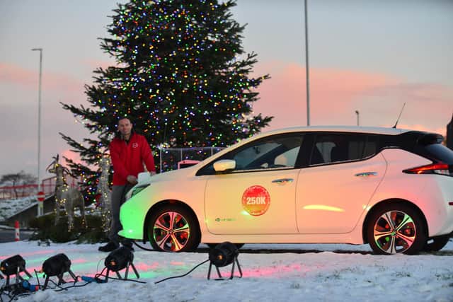 Nissan plant Vice President Manufacturing Alan Johnson plugs in the Christmas Tree lights