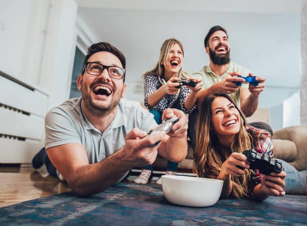 A group of friends playing video games together at home