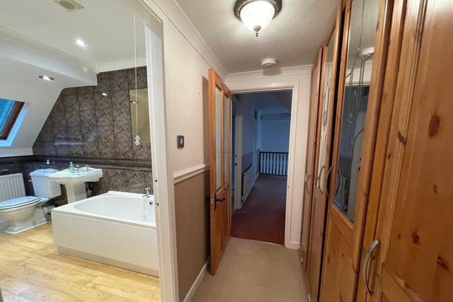 A rear hallway houses the stairs that lead to the first floor and a spacious, galleried landing that has a built-in storage cupboard. And then it's on to the superb master bedroom, which is approached via a dressing room and has full-height, built-in wardrobes.