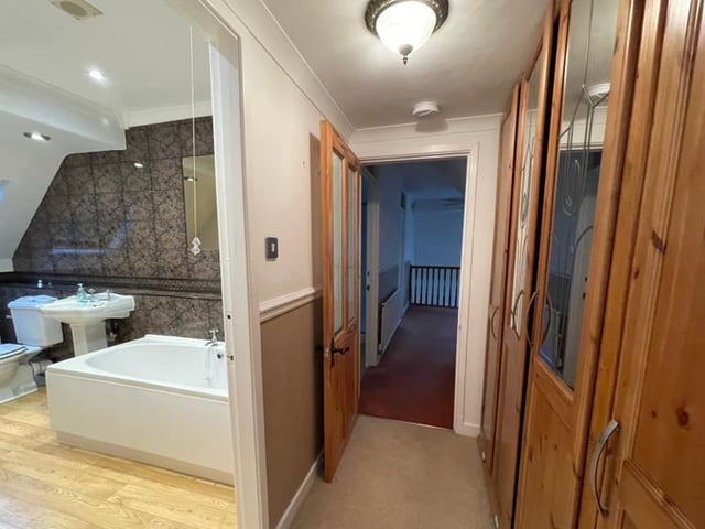 A rear hallway houses the stairs that lead to the first floor and a spacious, galleried landing that has a built-in storage cupboard. And then it's on to the superb master bedroom, which is approached via a dressing room and has full-height, built-in wardrobes.