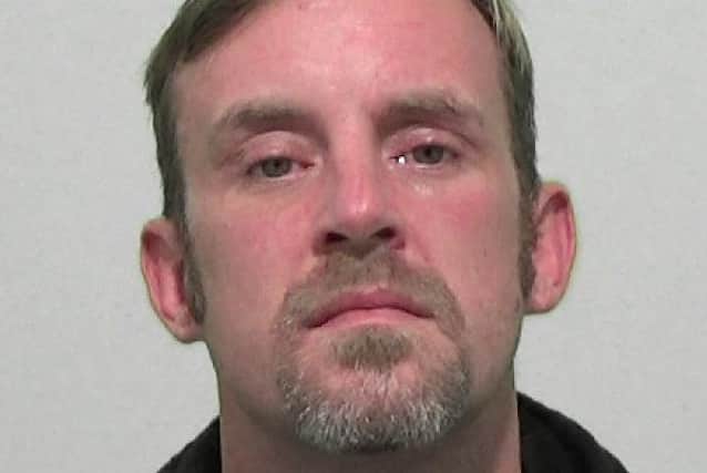 Michael Paul Sanders has been jailed after attacking two police officers in a police car.