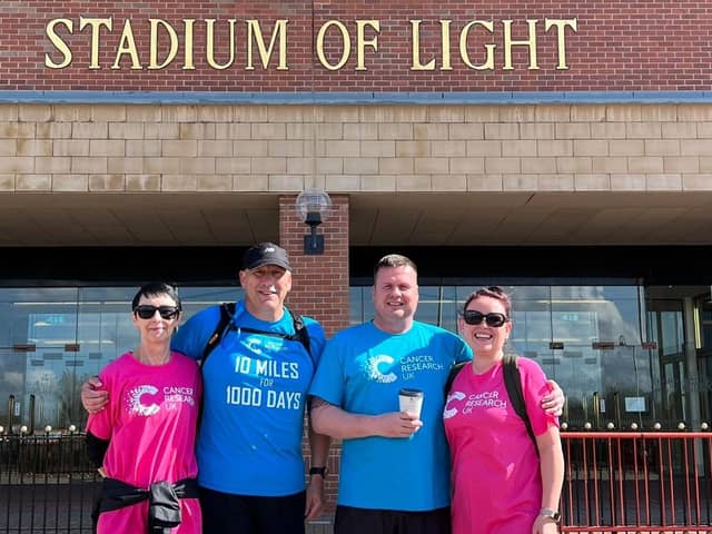 From left: David’s partner Denise, David and friends Jonathan and Luan Lathan, during a stop-off at a famous landmark.