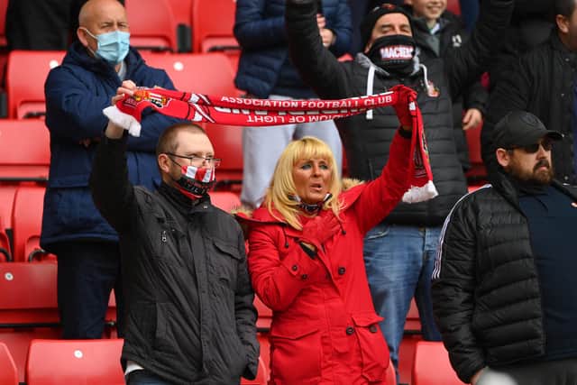 SUNDERLAND, ENGLAND - MAY 22: Sunderland fans enjoy the atmosphere with their scarf during the Sky Bet League One Play-off Semi Final 2nd Leg match between Sunderland and Lincoln City  at Stadium of Light on May 22, 2021 in Sunderland, England. (Photo by Stu Forster/Getty Images)