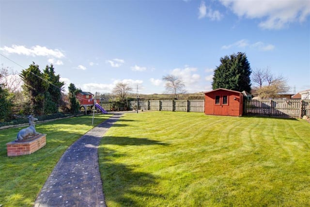 The house is complete with extensive south facing private and secluded grounds.