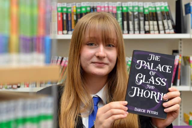 Year 10 pupil Darcie Peters, 14, with her newly published book The Palace of Glass and Thrones.