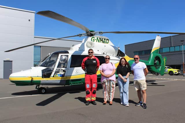 Marcus Johnson with Tanya, Simon and Ellen Brown by the GNAAS helicopter