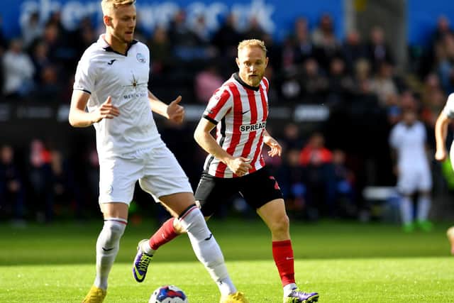 Alex Pritchard and Swansea defender Harry Darling. Picture by FRANK REID