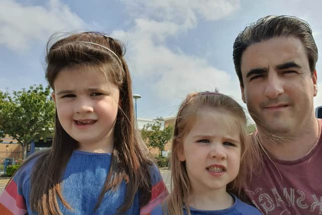 James with his and Sarah's children Amelia, 4 (left) and Isabella, 3.