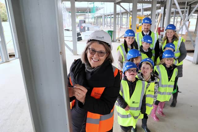 Councillor Louise Farthing signing the steel girders being erected as part of the construction of Sunningdale School.