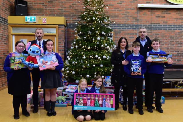 (left to right) Headteacher Lee Duncan, teacher Julie Stevens and Nick Hall from the Salvation Army with pupils Amy McMahon, Lucy Kemp, Kayla Jones, Megan Sewell, Ridley Coombs and Ryan Herron.