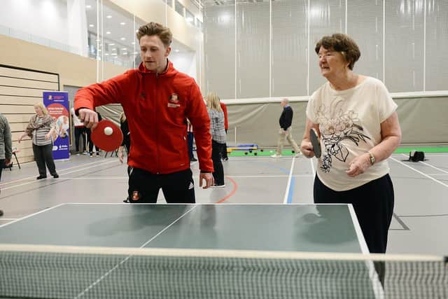 Sunderland AFC defender Denver Hume enjoying a game of table tennis with Jenny Plunkett during the EFL Day of Action held at the Beacon of Light.