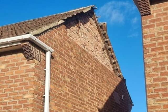A gable end damaged in the storms.
