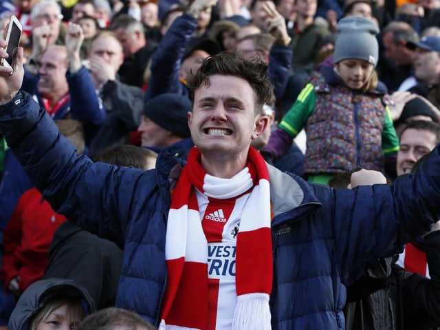 Sunderland fans celebrate after Jermain Defoe scores the equalising 1-1 goal during the Premier League football match between Stoke City and Sunderland at the Britannia Stadium on April 30, 2016.