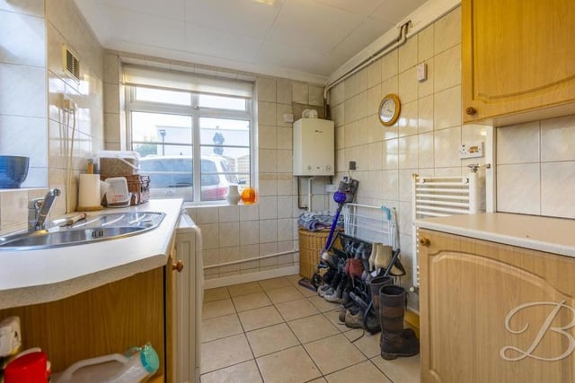 The bungalow's handy utility room can be used for just about anything. There is a range of units and cabinets with work surface over, an inset sink and drainer, and space and plumbing for a washing machine and tumble dryer.