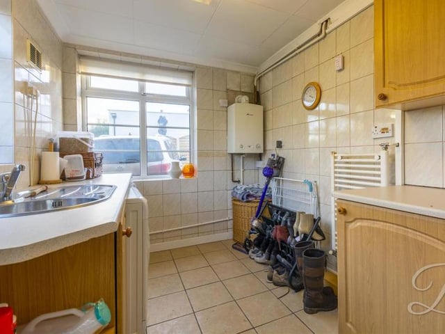 The bungalow's handy utility room can be used for just about anything. There is a range of units and cabinets with work surface over, an inset sink and drainer, and space and plumbing for a washing machine and tumble dryer.