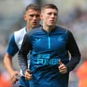 Newcastle United's English midfielder Elliot Anderson warms up prior to the English Premier League football match between Newcastle United and Manchester City at St James' Park in Newcastle-upon-Tyne, north east England, on August 21, 2022.(Photo by LINDSEY PARNABY/AFP via Getty Images)